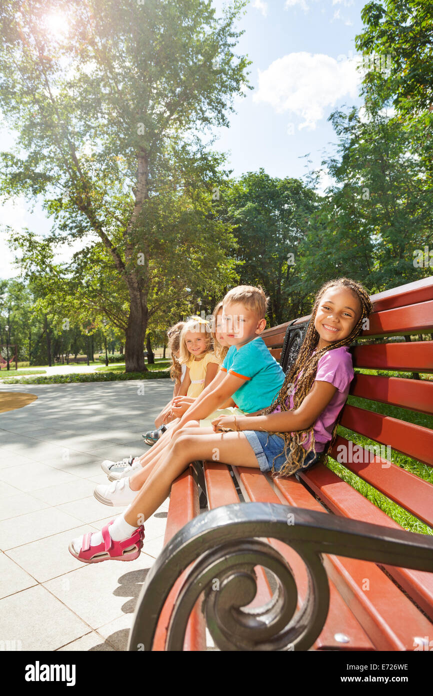 Kids sitting on park bench hi-res stock photography and images - Alamy