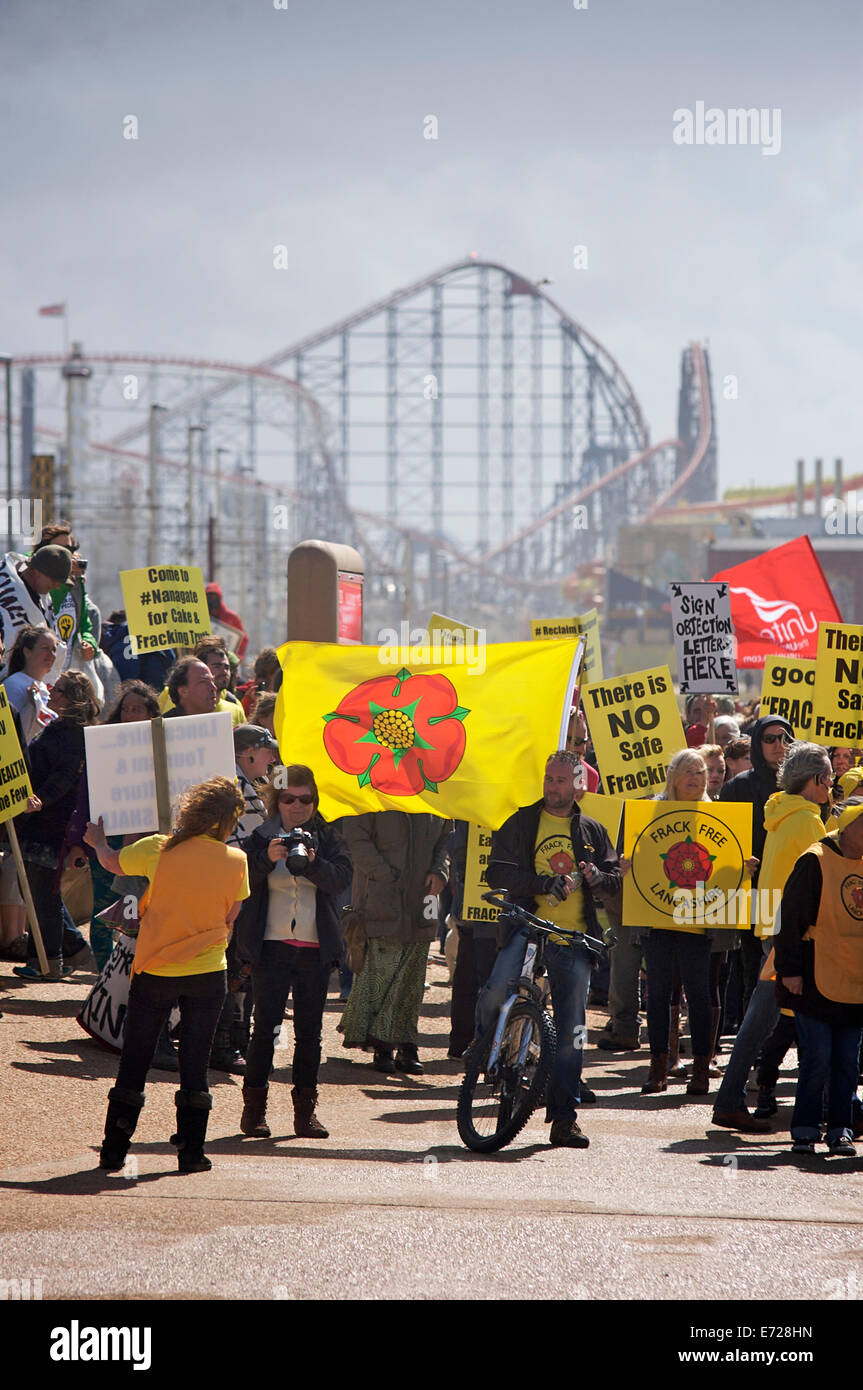 Anti fracking march along Blackpool Promenade with the Big One roller coaster on the Pleasure Beach in the background. Stock Photo