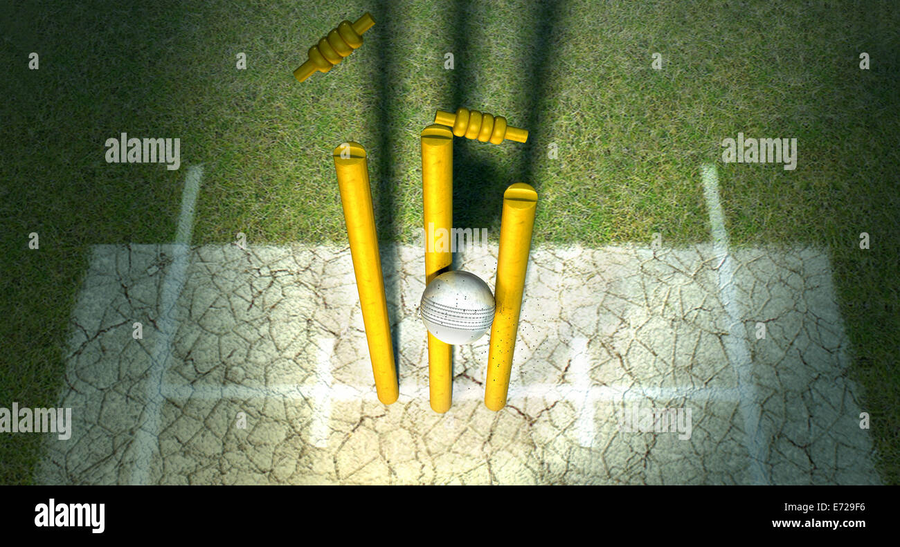 A white leather cricket ball hitting wooden cricket wickets on a grass