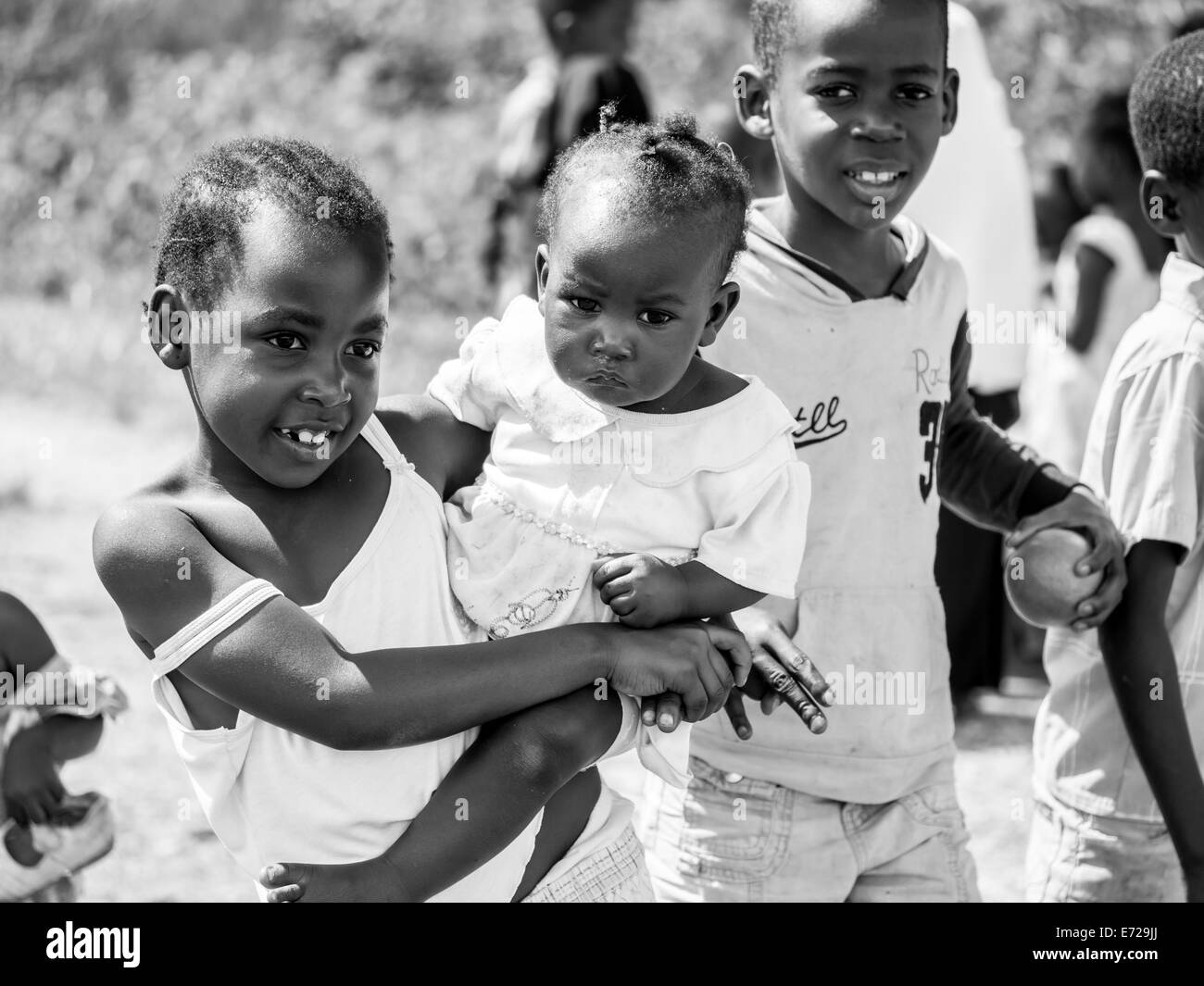 Local children asking people to take photos of them on Zanzibar island. Stock Photo
