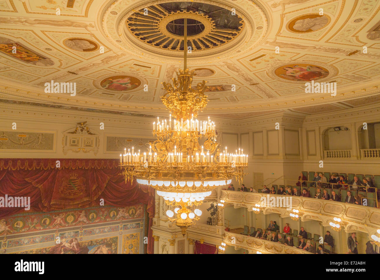 Interior view of the Semperoper opera house, chandelier on the stuccoed ceiling and the 'five-minute clock', Dresden, Saxony Stock Photo