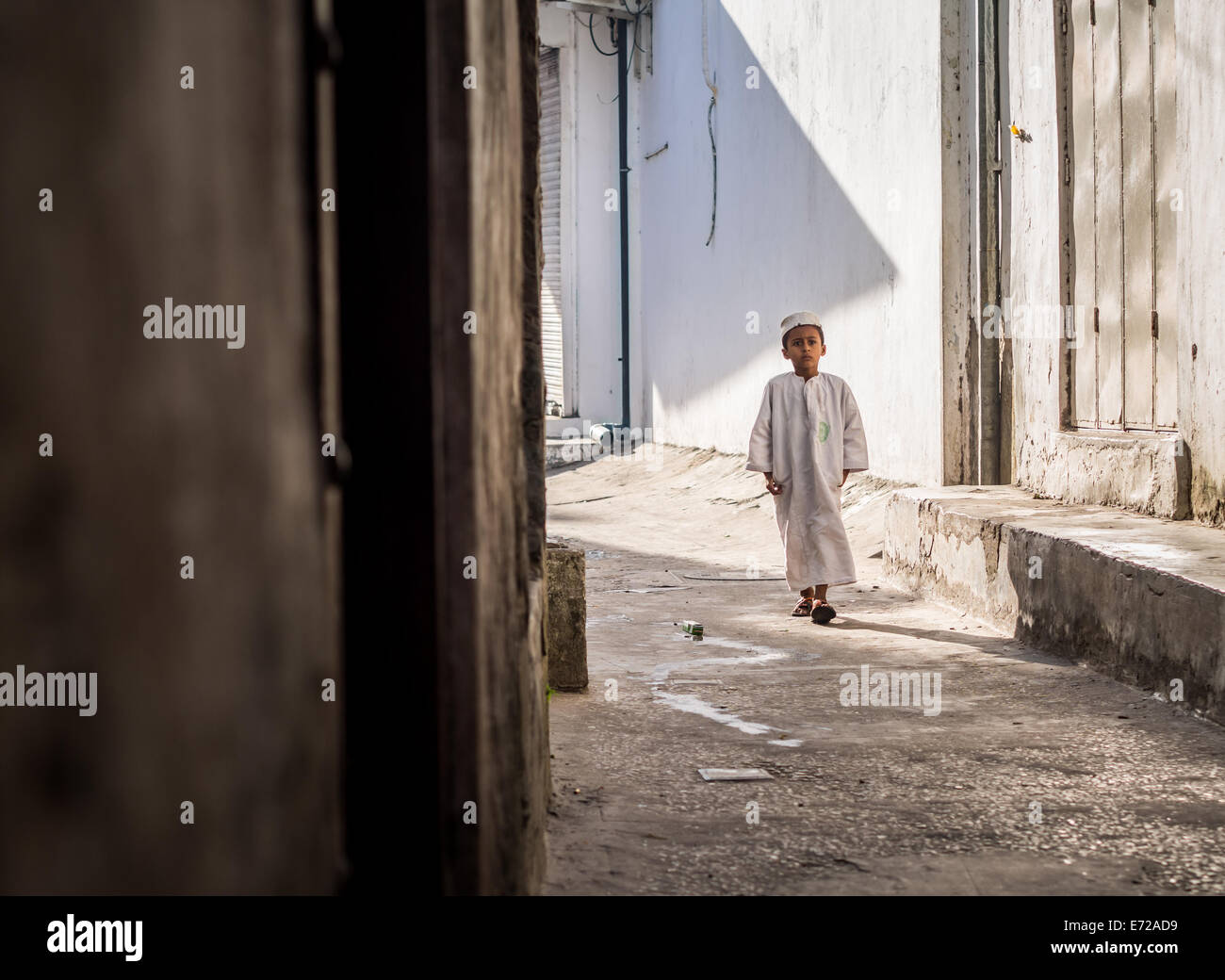A schoolboy in his uniform on one of the streets of Stone Town on Zanzibar island. Stock Photo