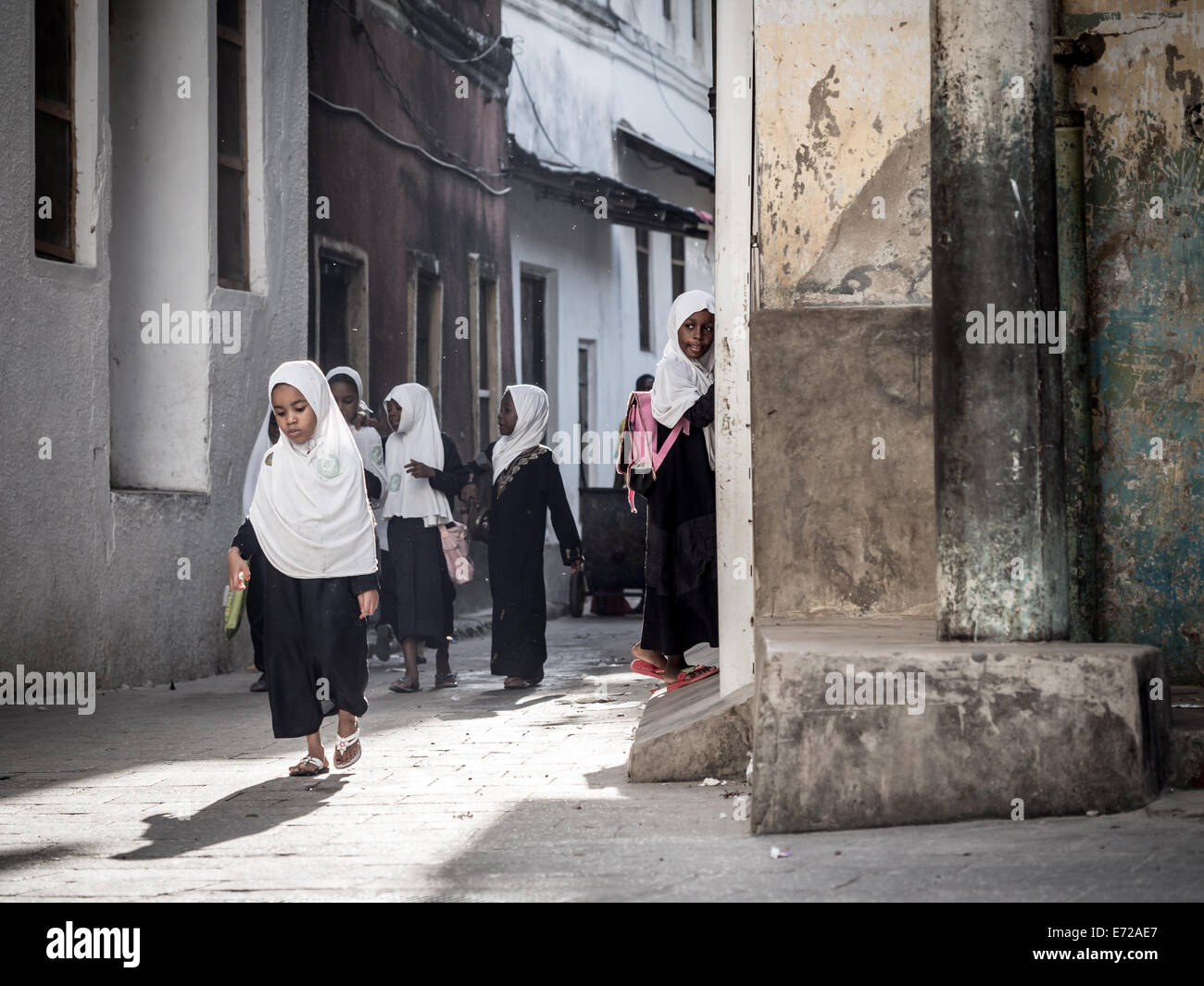 Schoolgirls on one of the streets of Stone Town on Zanzibar island. Stock Photo