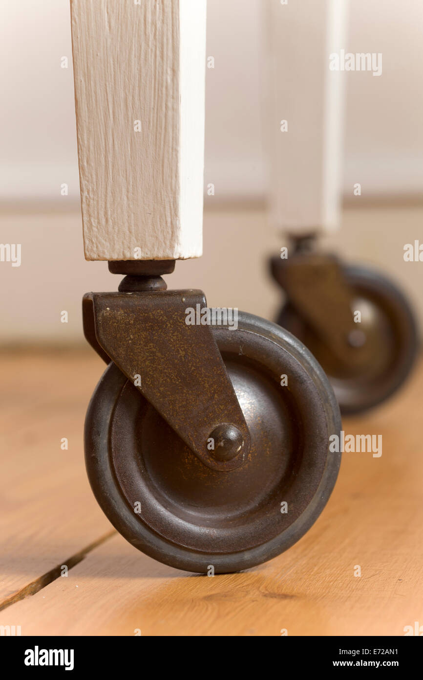 Swivel wheels of wooden serving trolley Stock Photo