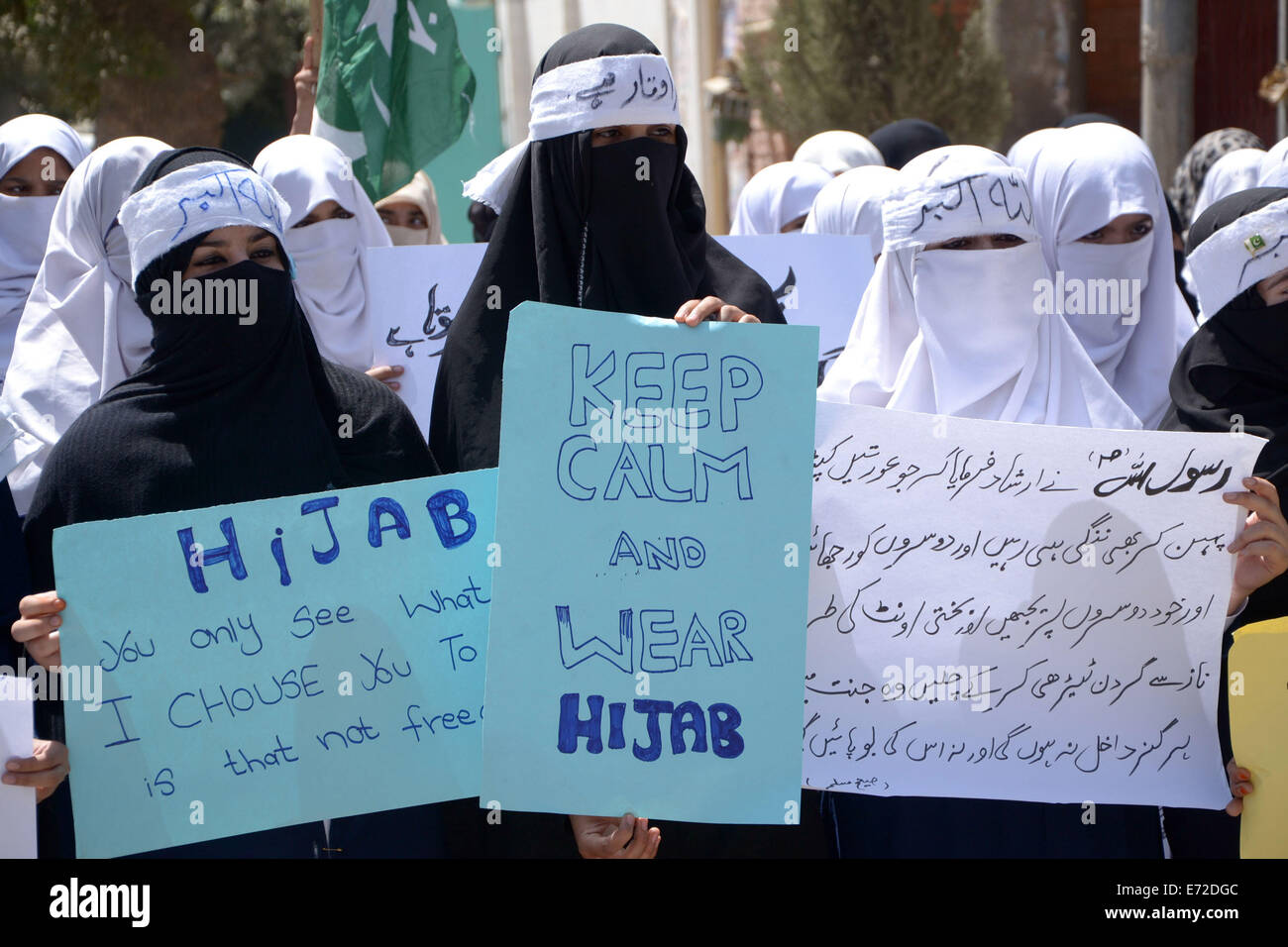 Quetta. 4th Sep, 2014. Pakistani women covering their faces with Hijab hold placards during a rally to mark World Hijab Day in southwest Pakistan's Quetta, Sept. 4, 2014. Nationwide rallies were organized to highlight the importance and value of hijab for Muslim women in Pakistan. Credit:  Asad/Xinhua/Alamy Live News Stock Photo