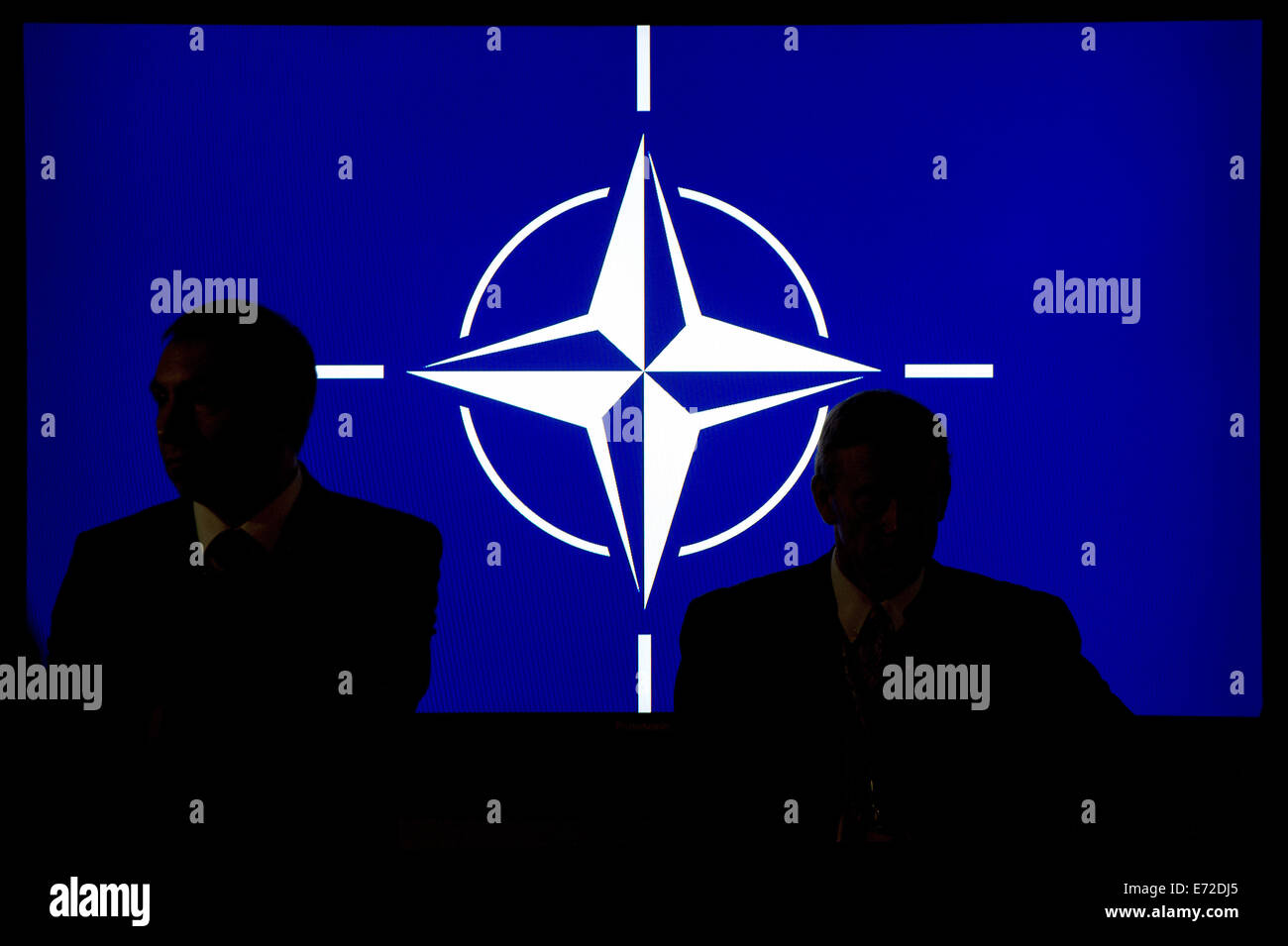 Newport, South Wales. 4th Sep, 2014. Participants sit in front of the Nato logo during the NATO summit in Newport, South Wales, 4 September 2014. World leaders from about 60 countries are coming together for a two-day NATO summit taking place from 04-05 September 2014. PHOTO: MAURIZIO GAMBARINI/dpa/Alamy Live News Stock Photo