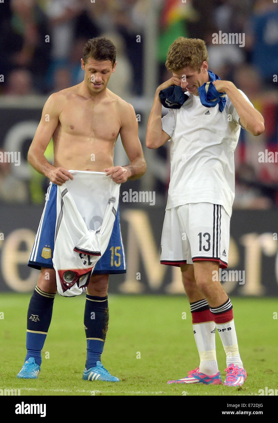 Duesseldorf, Germany. 03rd Sep, 2014. Argentina's Martin Demichelis (L) and Germany's Thomas Mueller swop shirts during the international match between Germany and Argentina at Esprit Arena in Duesseldorf, Germany, 03 September 2014. Photo: Federico Gambarini/dpa/Alamy Live News Stock Photo