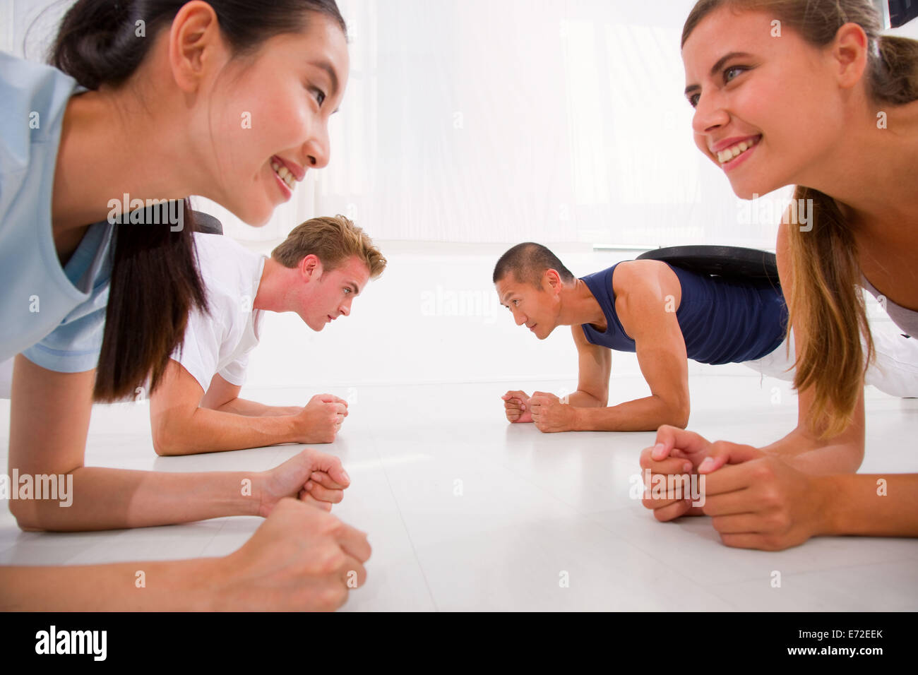 Young multi ethnic people exercising in gym Stock Photo