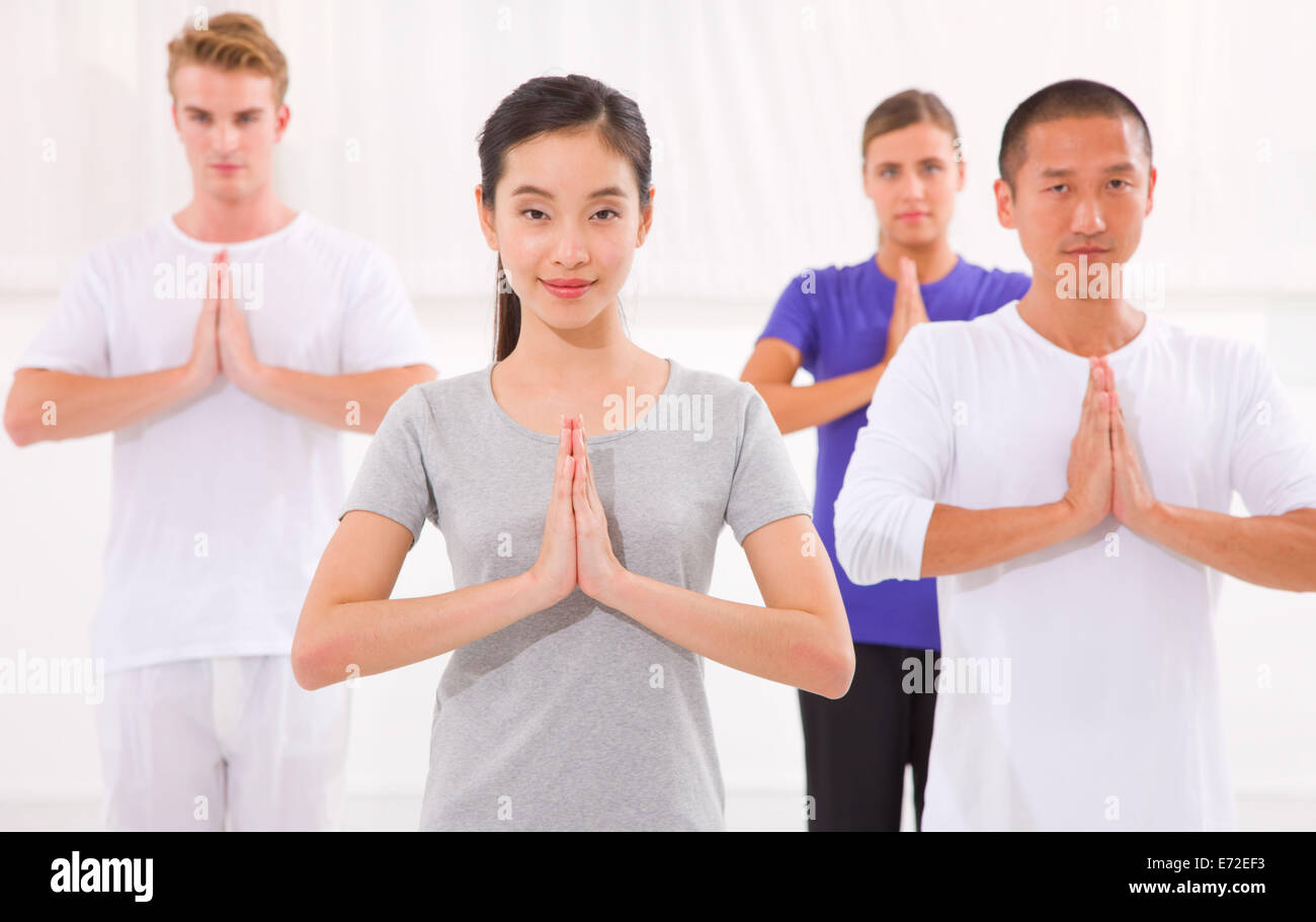 Multi ethnic group of happy people doing yoga Stock Photo