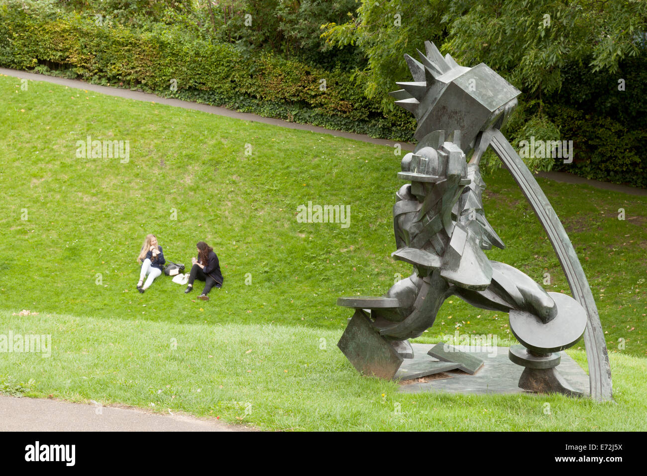 A couple and a statue, Temple Gardens, Lincoln city, UK Stock Photo