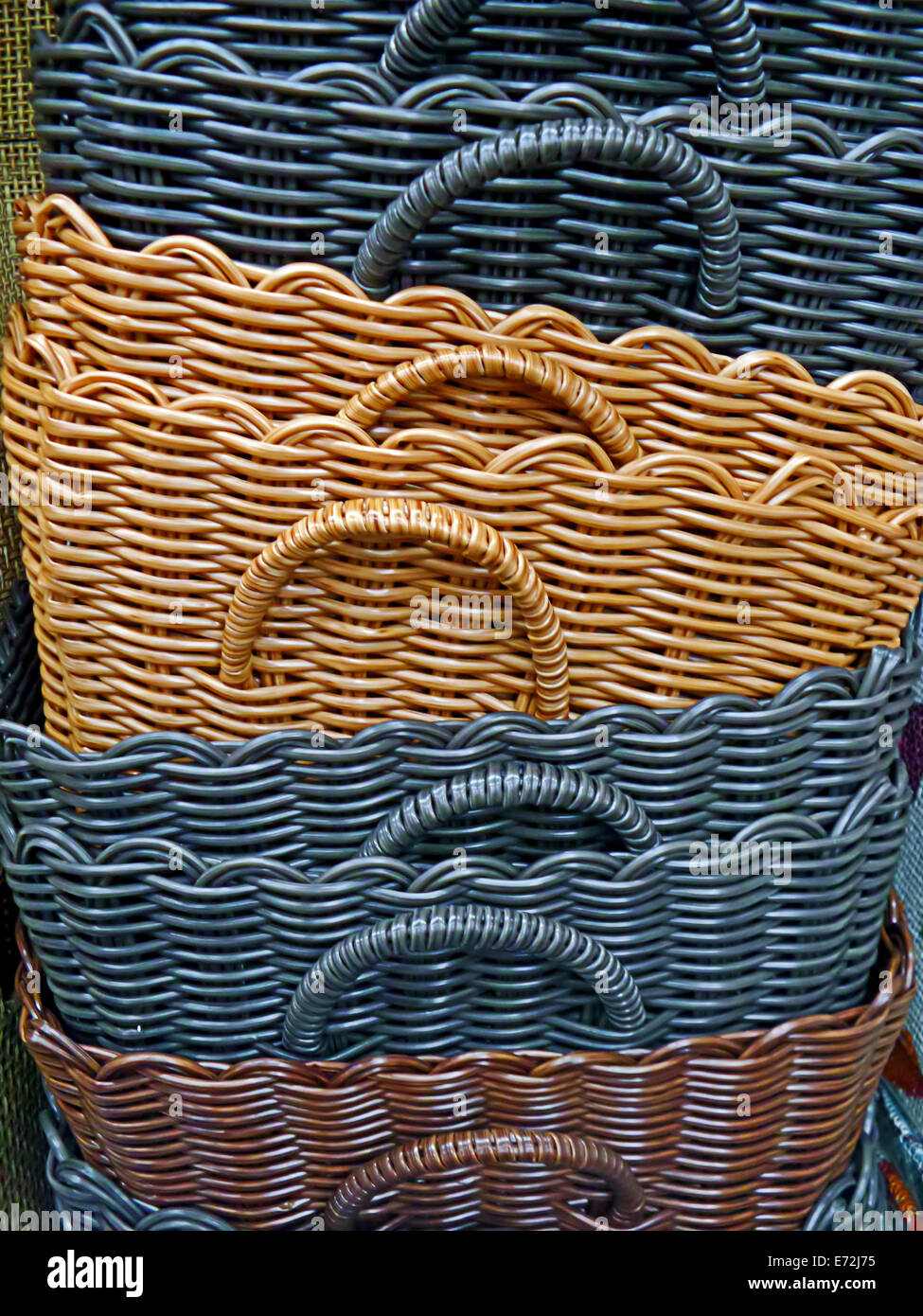 Colored wicker baskets stacked, used in the home Stock Photo Alamy