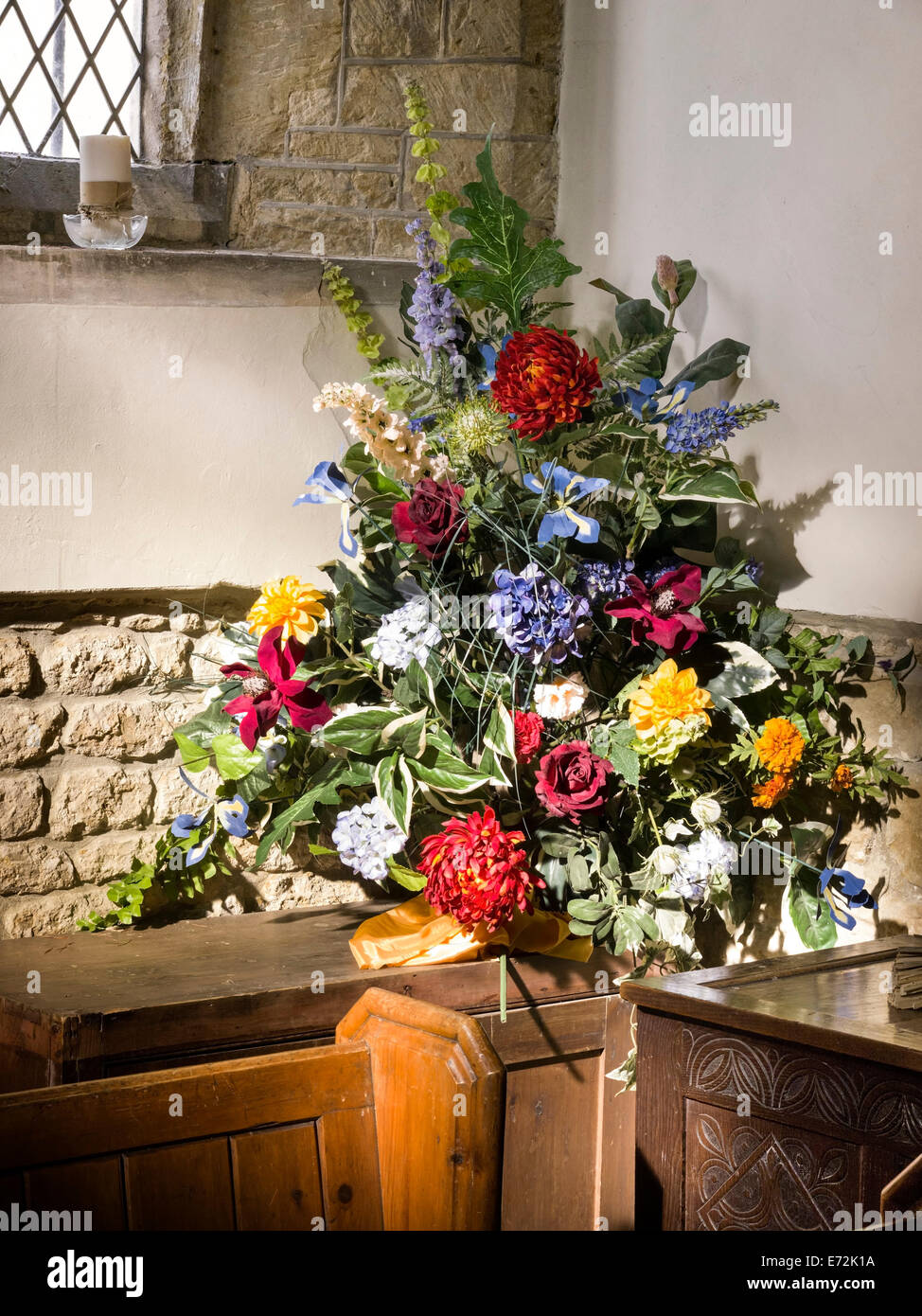 Arrangement of flowers in church Stock Photo