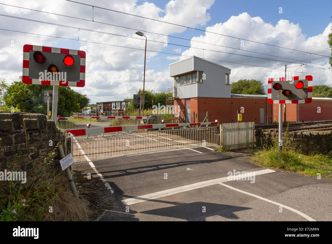 Train Tram Hagside Level Crossing With Disused Signal Box Signals And Barriers Lowered In Manchester Stock Photo Alamy