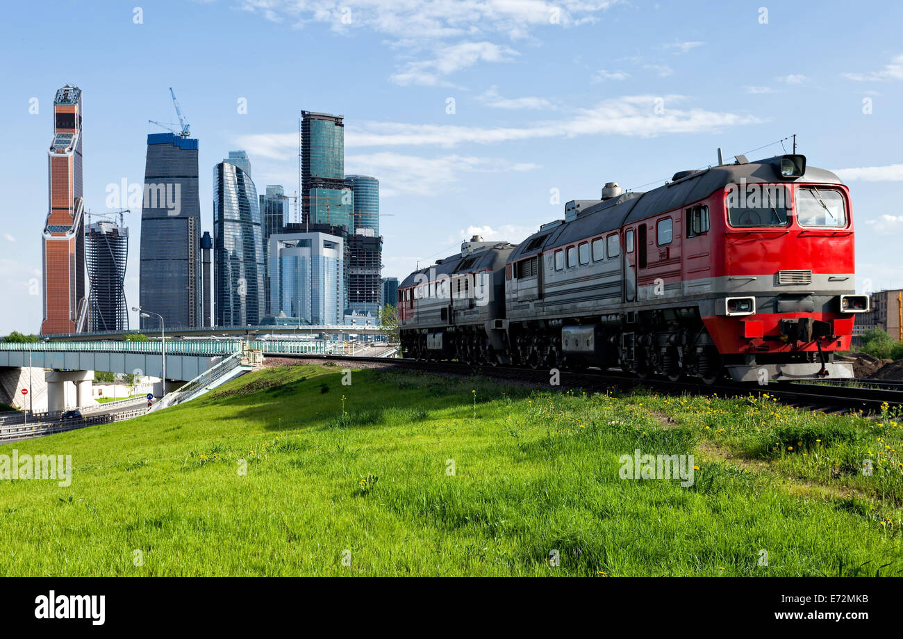 Green lawn and red train with Moscow-city on the background Stock Photo