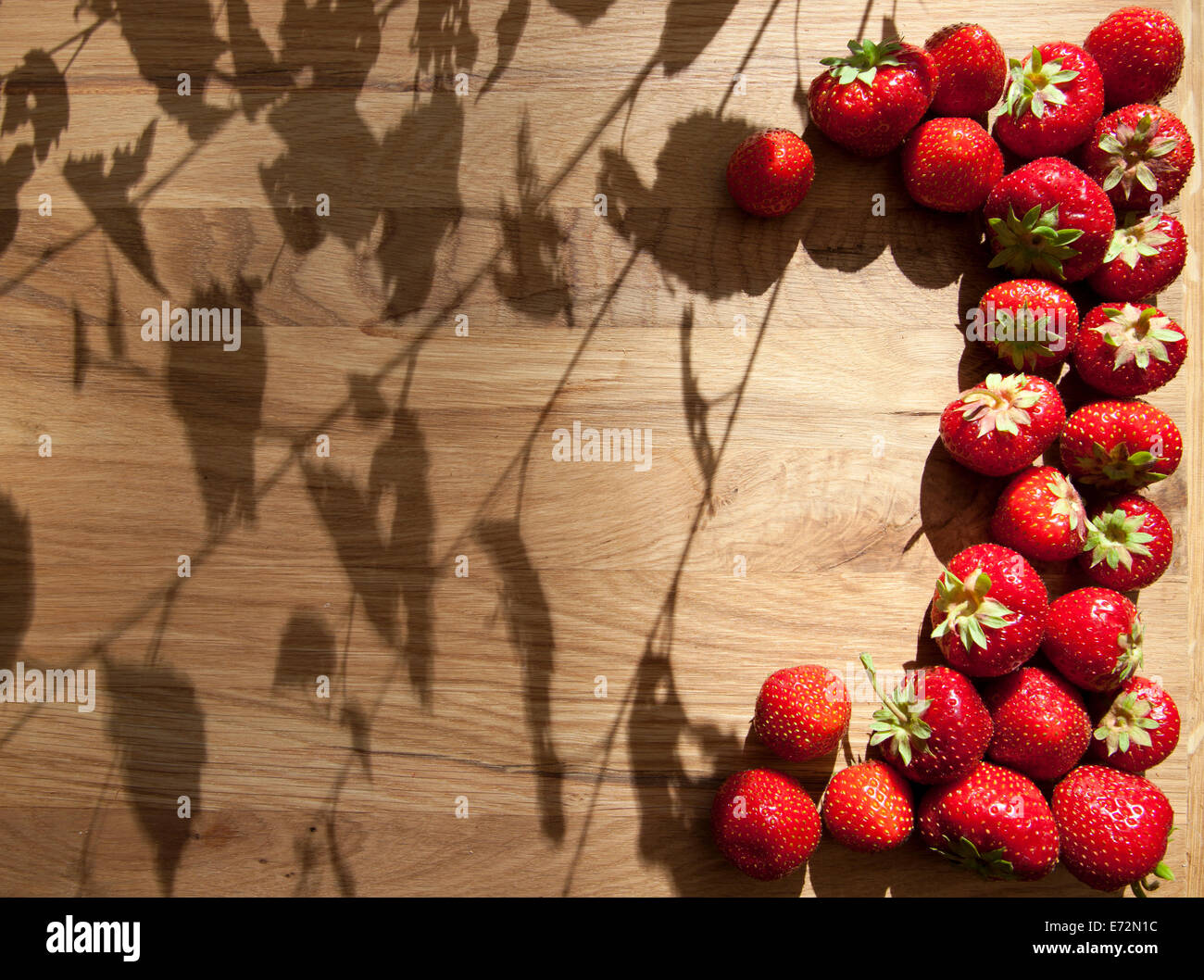 Fresh ripe red strawberries on wooden textured table top Stock Photo