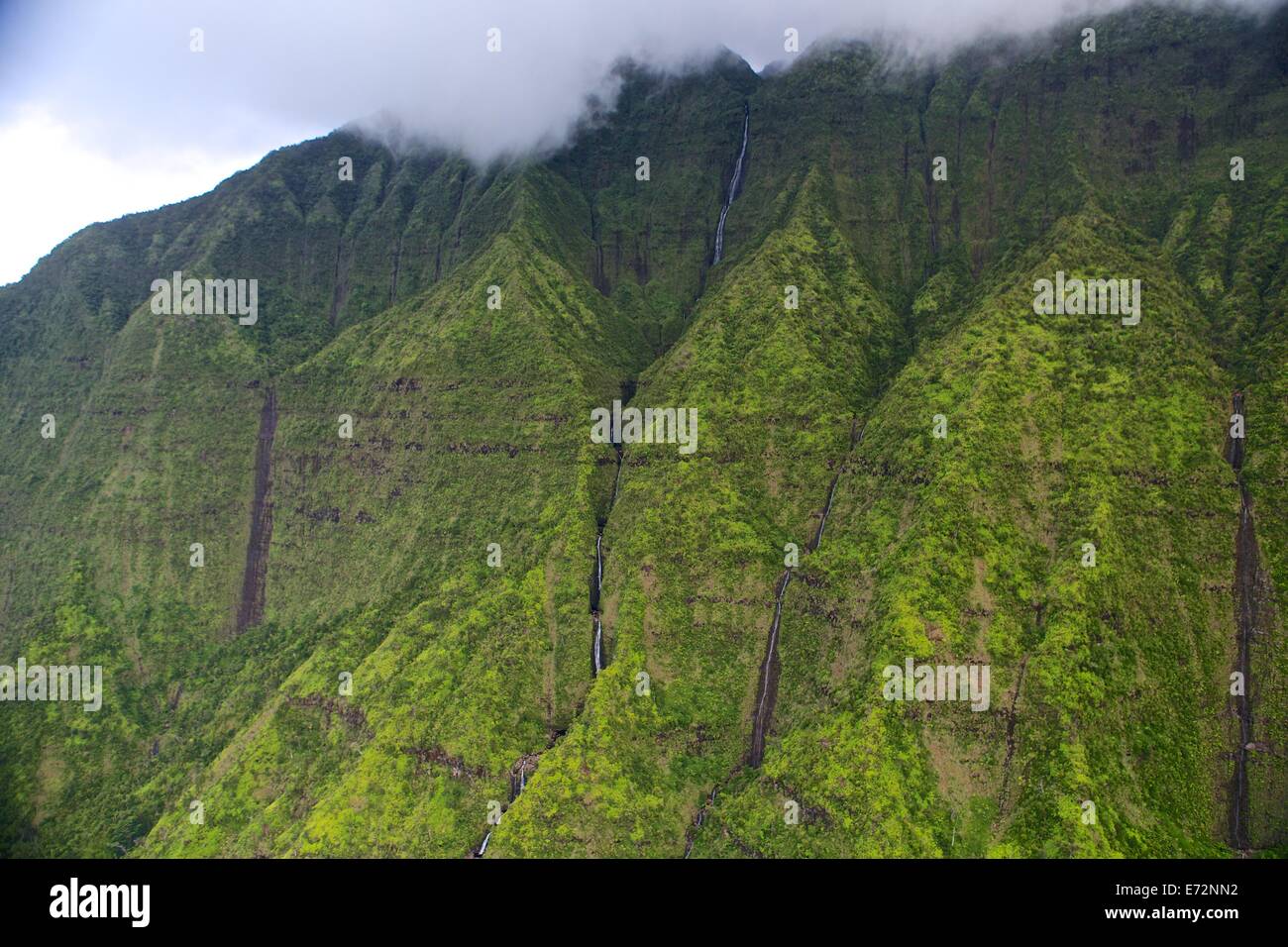 Aerial views of mountains and waterfalls from a helicopter in Kauai Stock Photo