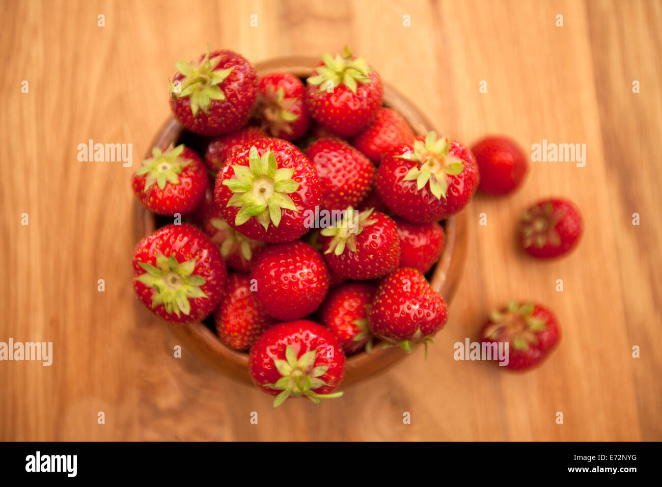 Fresh strawberries in wood bowl on table Stock Photo - Alamy