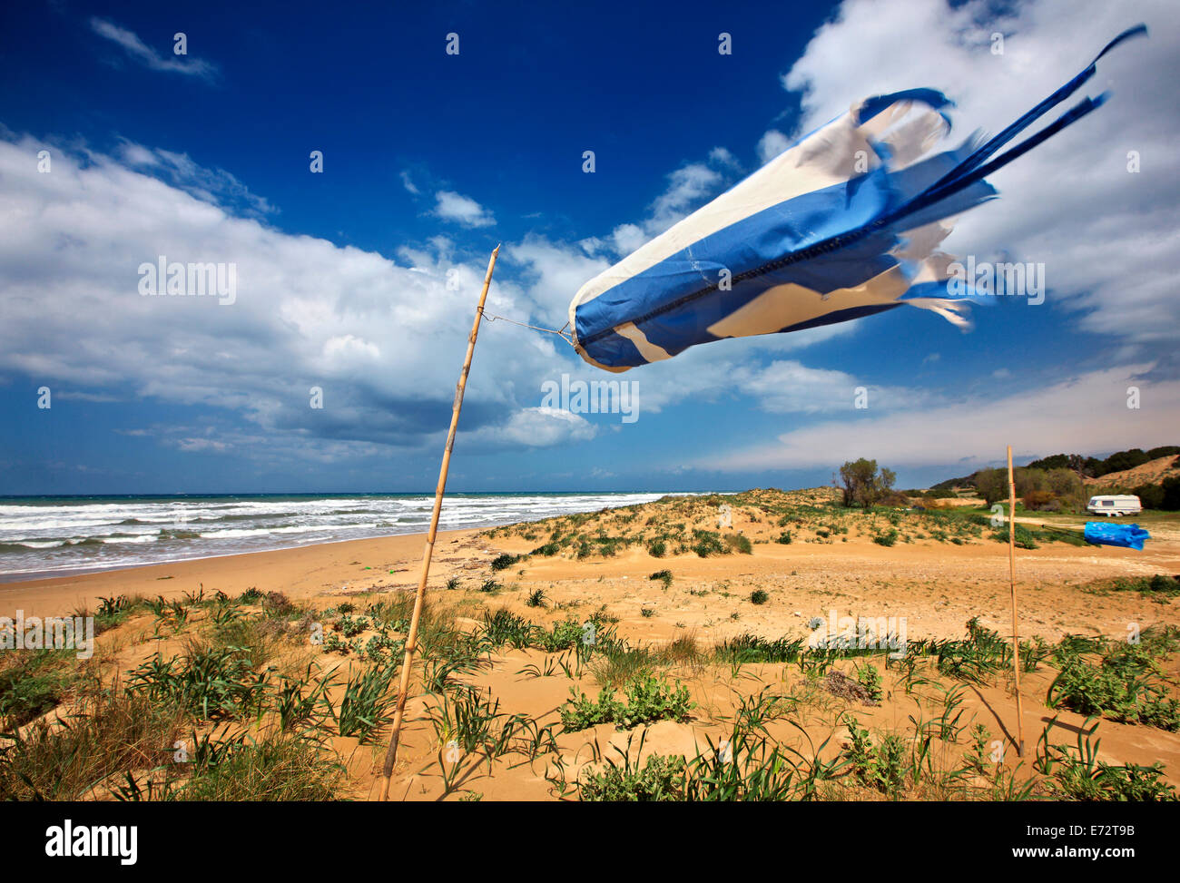 The beach of Kastro Kyllinis, and a wind sock with the colors of the Greek flag. Ilia , Peloponnese, Greece. Stock Photo