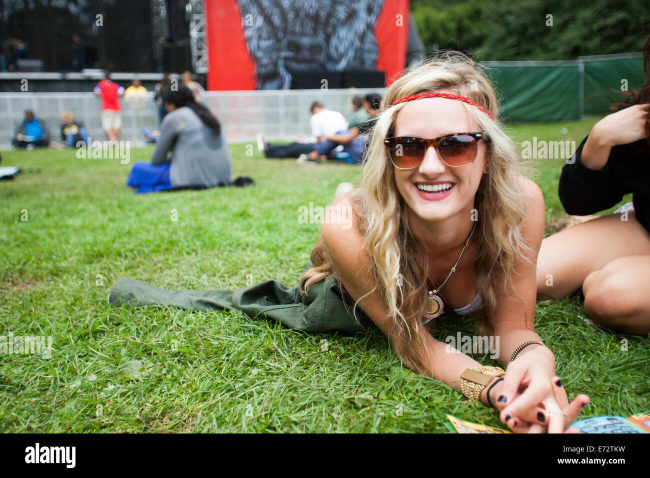 Portrait of young woman lying on ground Stock Photo