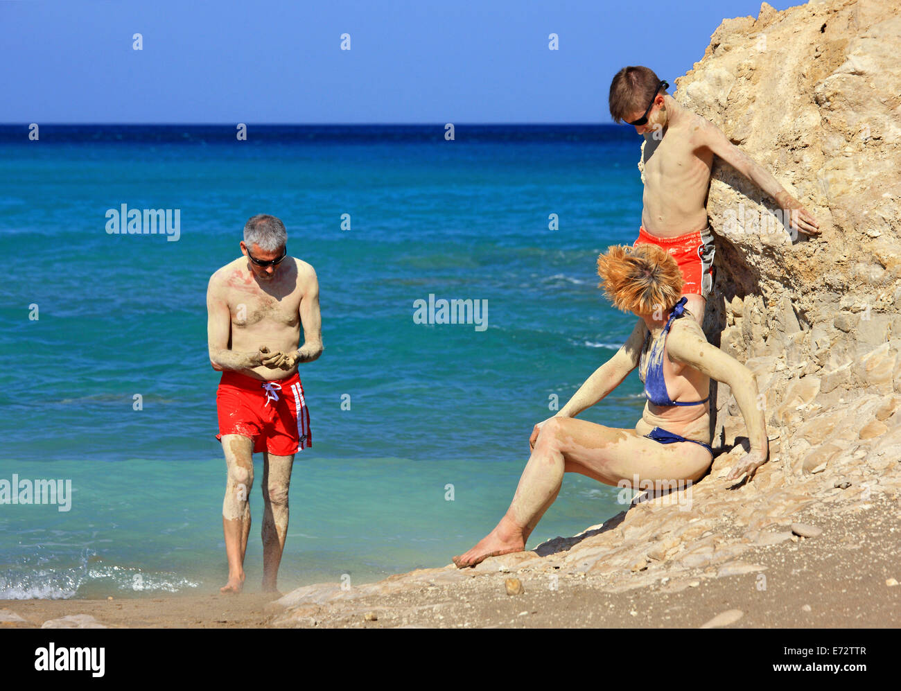 Family having a 'mudbath' at Argilos beach, Xerokambos, Sitia, Lasithi, Crete island, Greece. Stock Photo