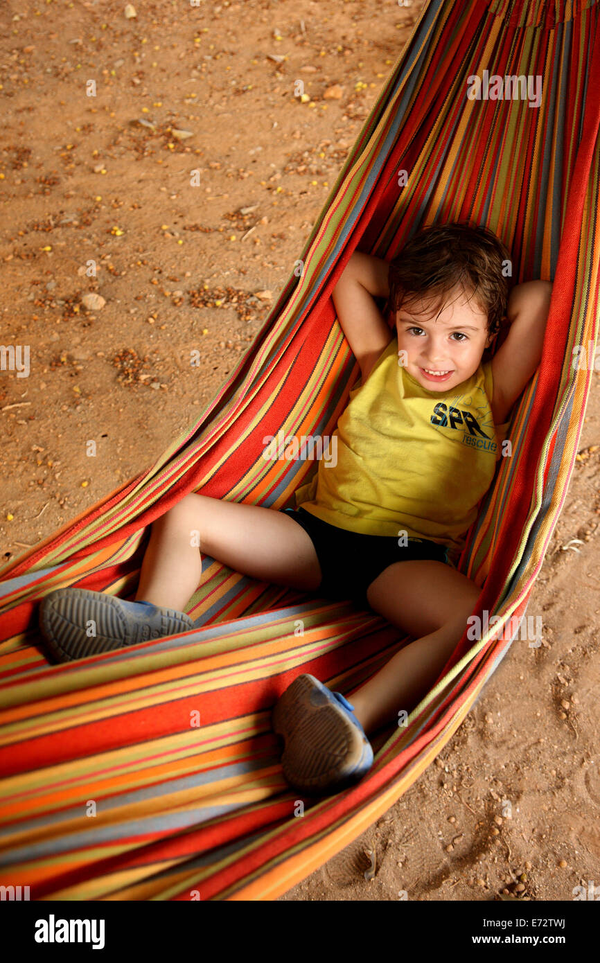 Toddler relaxing on a hammock at Xerokambos, Sitia, Lasithi, Crete island, Greece Stock Photo