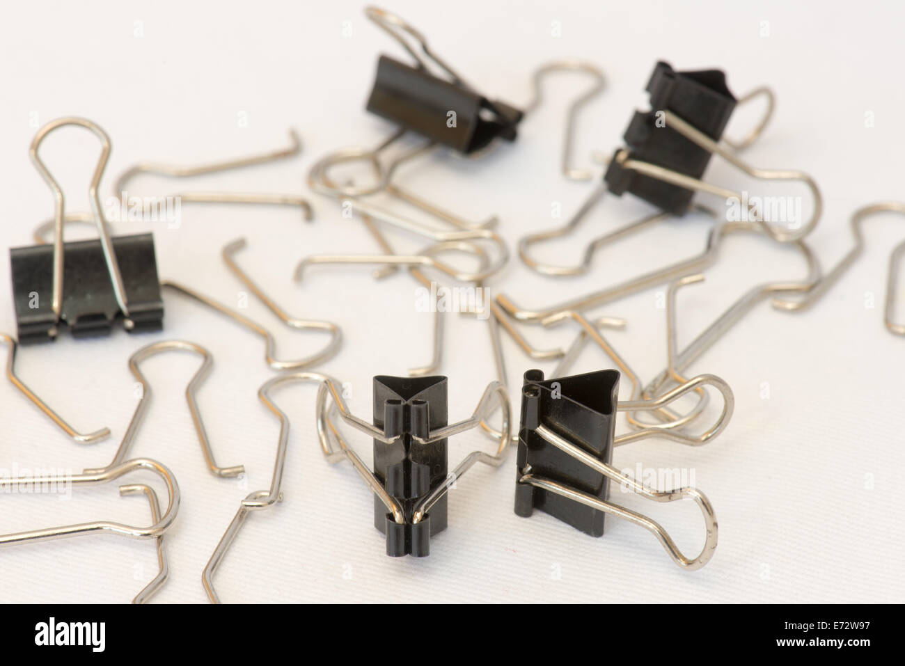 Closeup of several paper clips in different positions and arranged randomly. Stock Photo