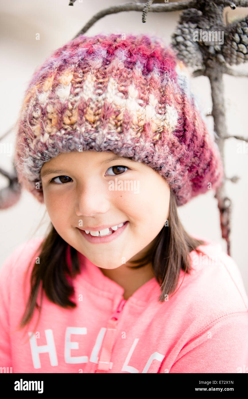 Portrait of smiling girl (6-7) wearing knit hat Stock Photo