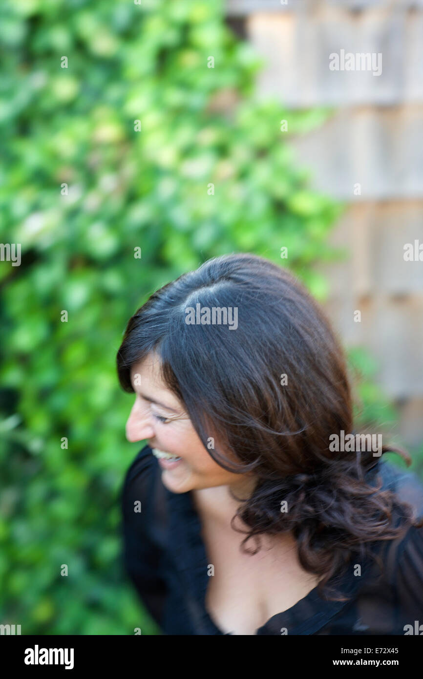 Laughing woman with long black hair Stock Photo
