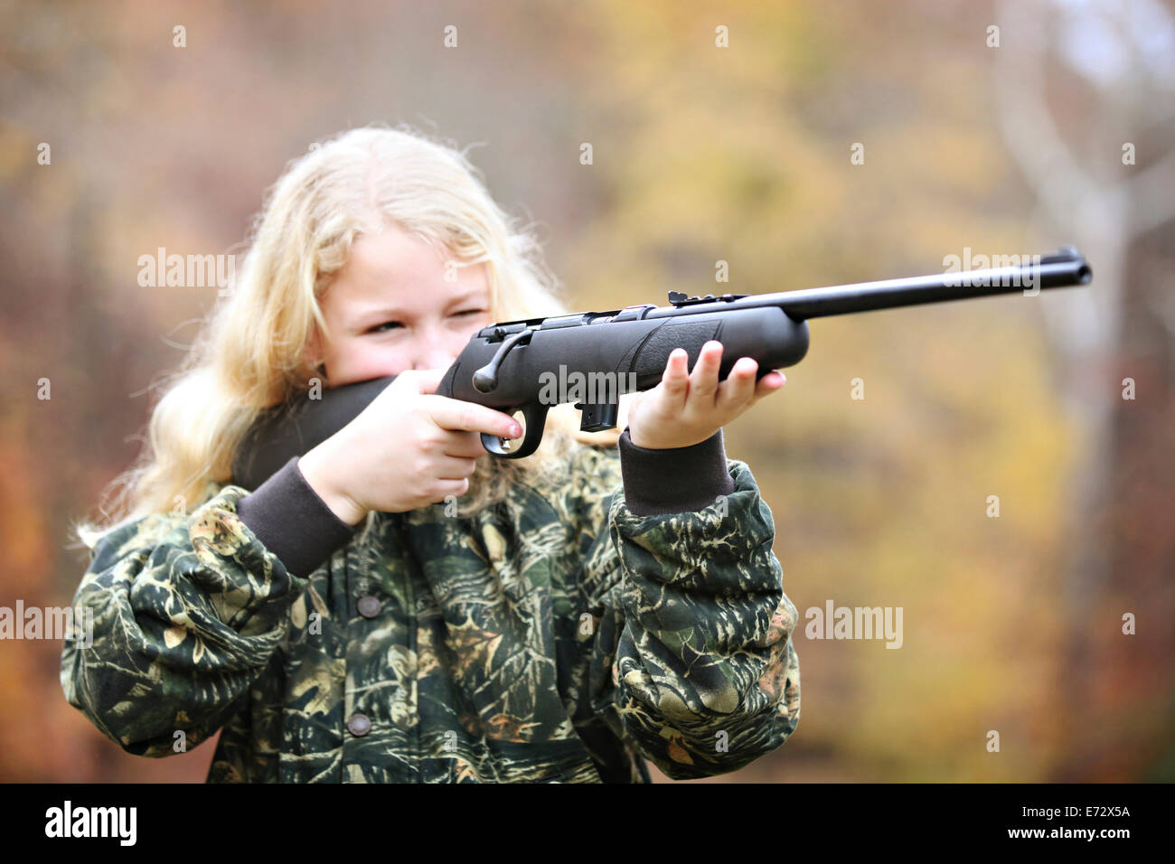 Girl (16-17) shooting rifle Stock Photo