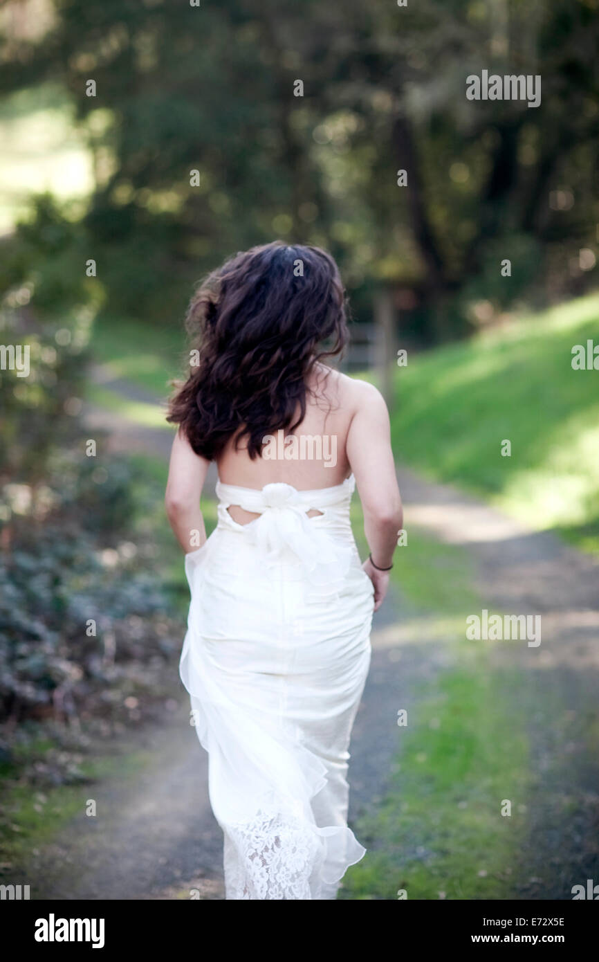 Woman in wedding dress running Stock Photo Alamy