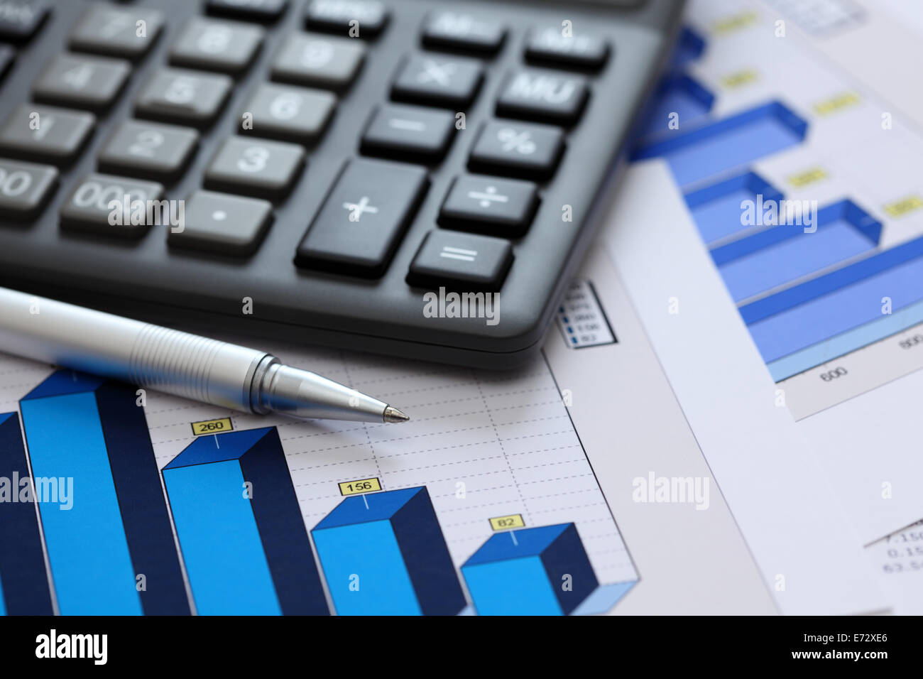 Financial statements. Business Graph. Ballpoint pen and calculator on a financial chart or Stock Market Data. Closeup. Stock Photo