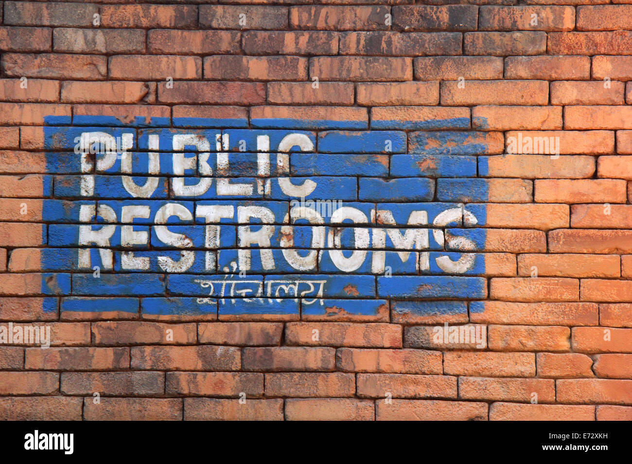 Public restrooms sign with Hindi writing below Stock Photo Alamy