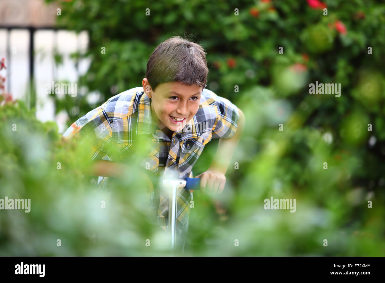 Young boy playing on a scooter Stock Photo