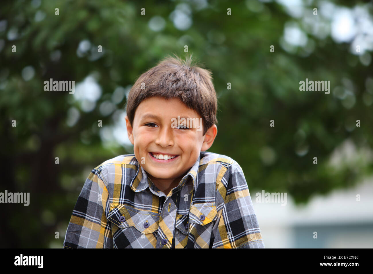 Portrait of a happy young boy outside Stock Photo