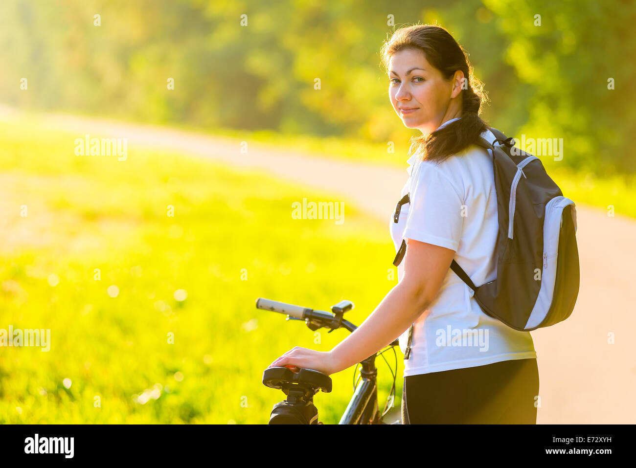 beautiful athlete with a backpack on a bicycle Stock Photo