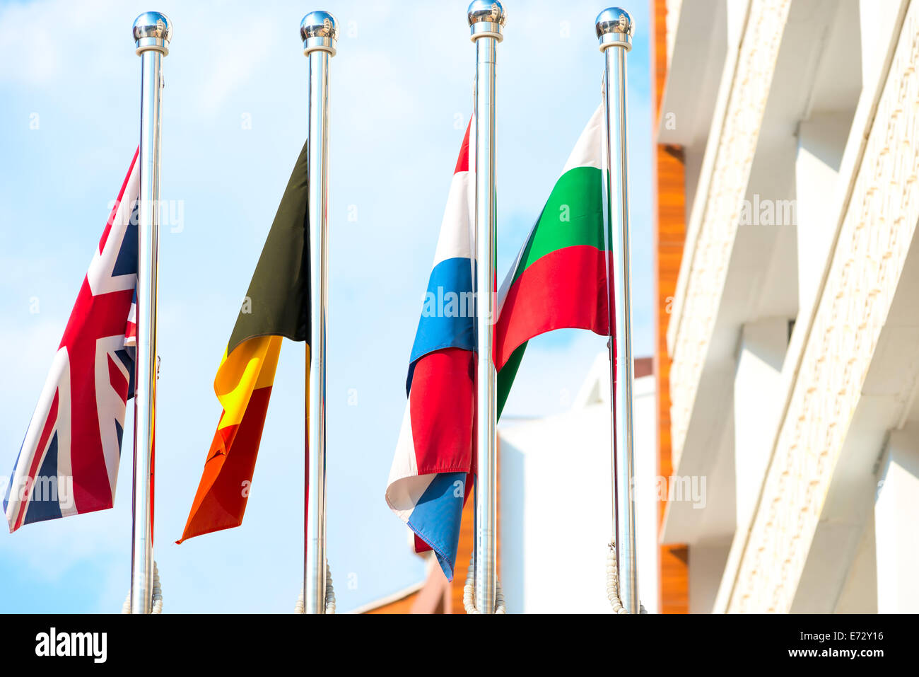 four flags on flagpoles countries Stock Photo Alamy