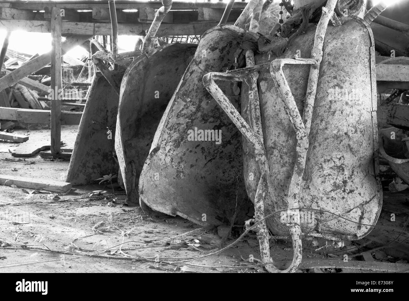 old wheel barrows for construction store at warehouse / black & white picture Stock Photo