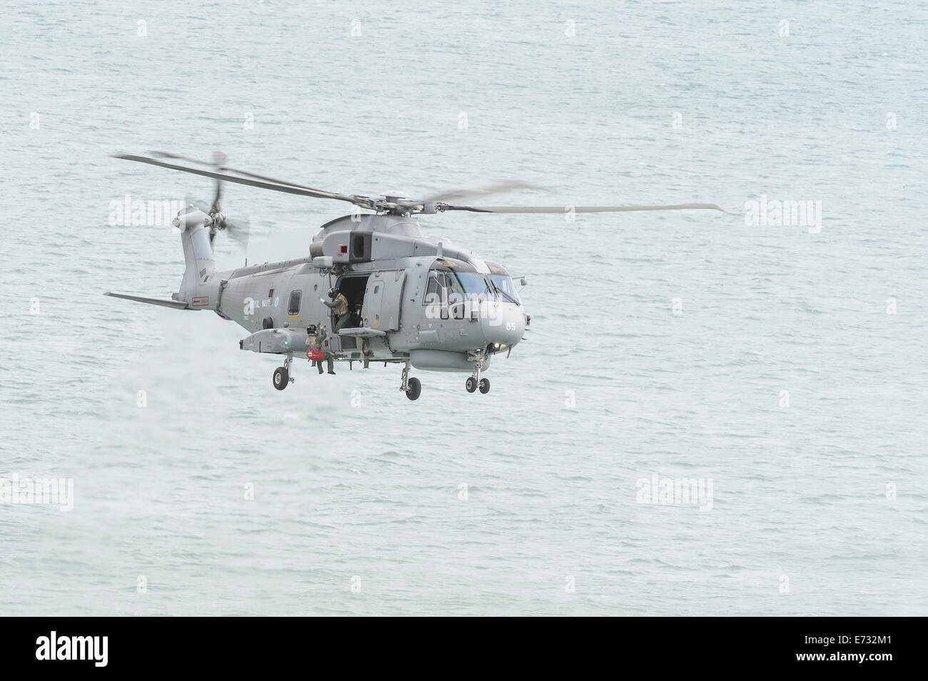 A Royal Navy Merlin HM1 Helicopter demonstrates its ability to lower a