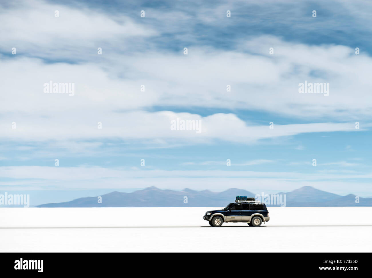 Car driving across Uyuni salt flats or Salar de Uyuni (or Salar de Tunupa) in Potosi Bolivia, South America Stock Photo