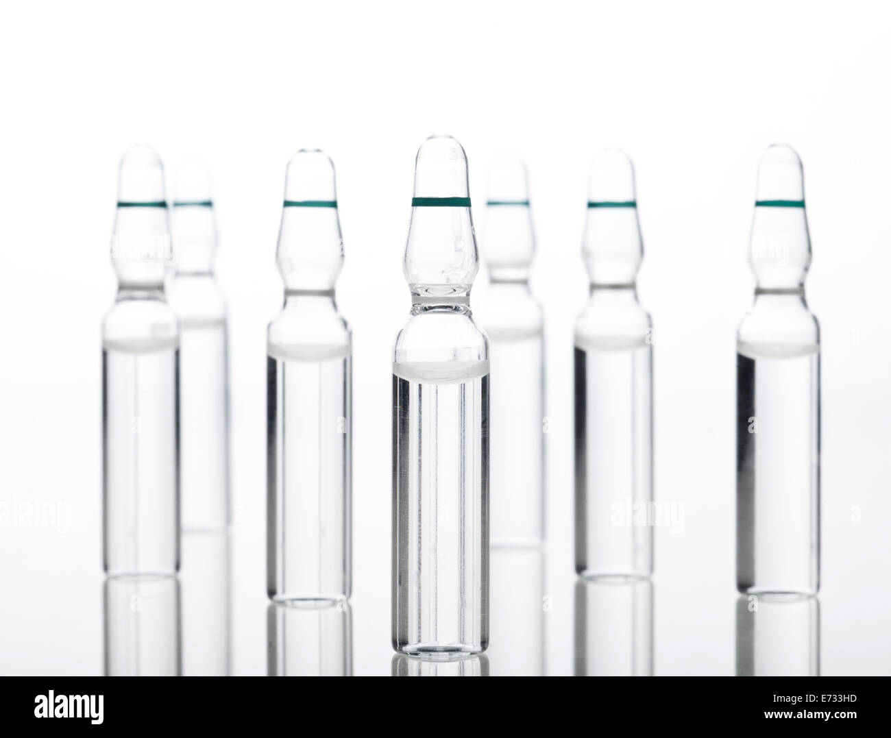 Glass Medicine Ampoules with liquid on a white background Stock Photo