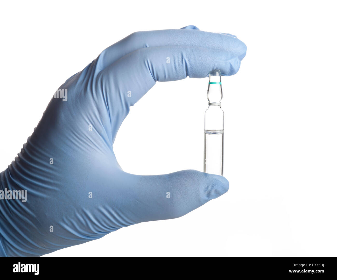Hand holding a Glass Medicine Ampoules with liquid on a white background Stock Photo