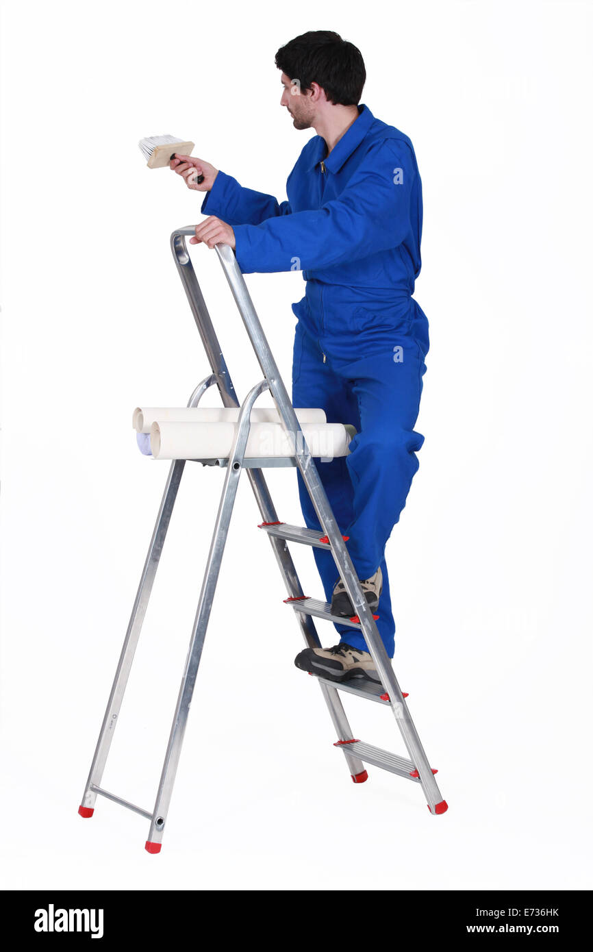 painter in jumpsuit on ladder isolated on white Stock Photo