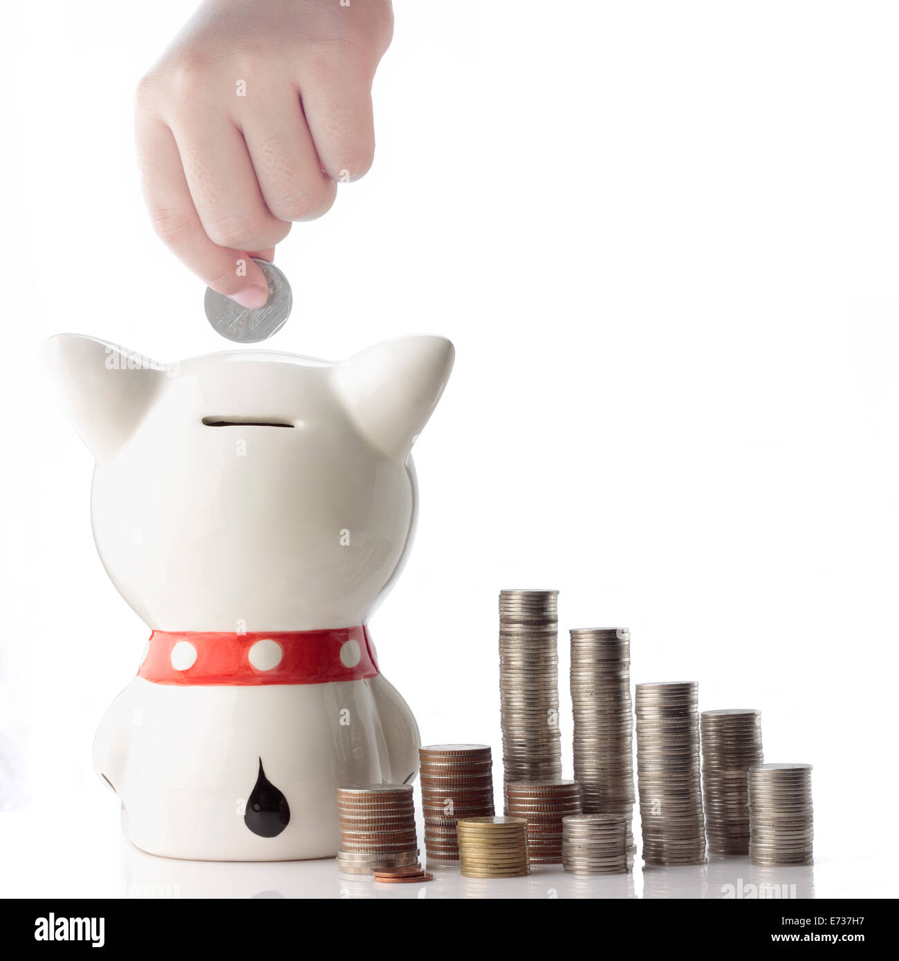 a hand saving coin in piggy bank on white background Stock Photo - Alamy