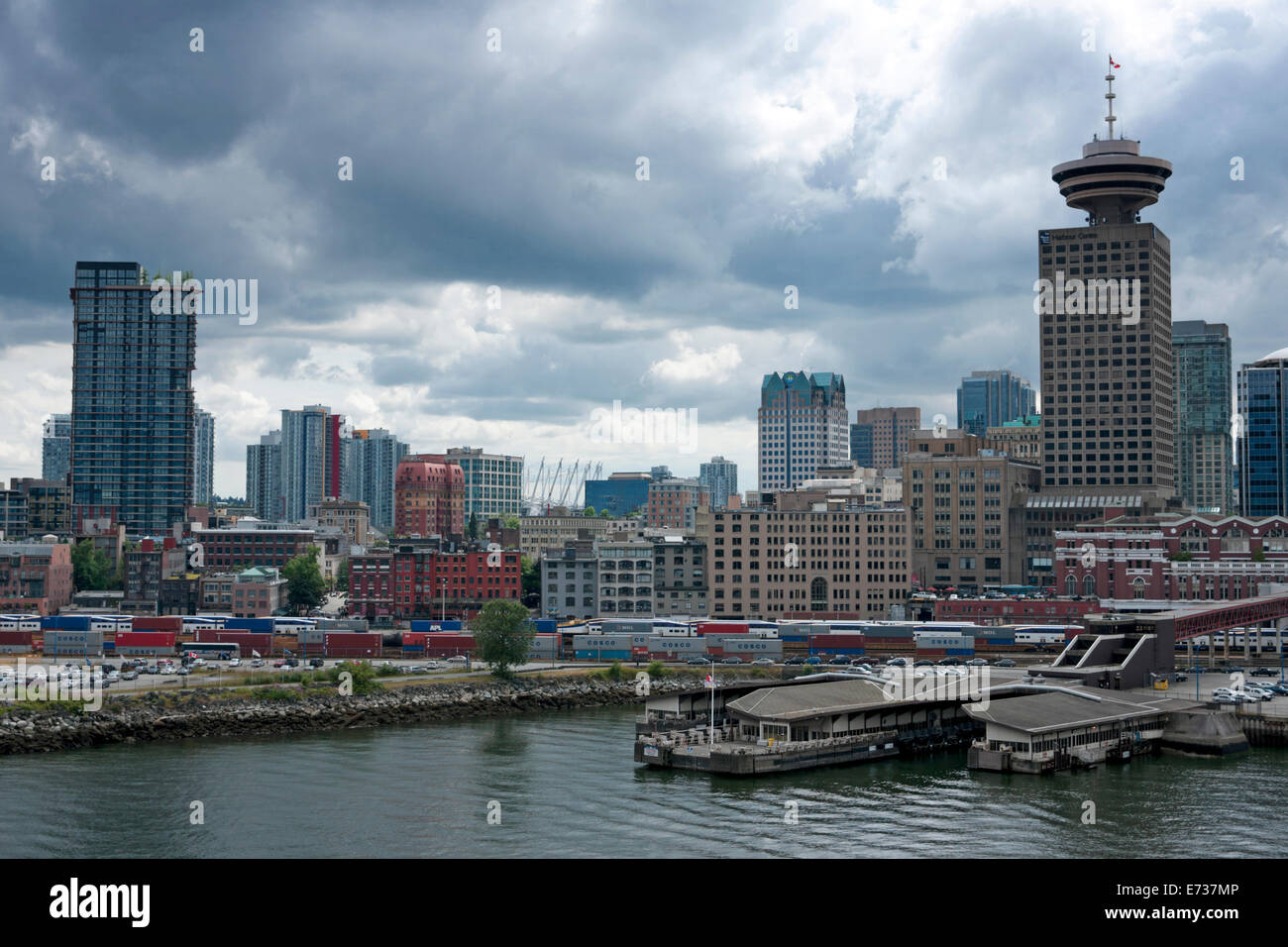 Harbor and partial skyline under cloudy skies in Vancouver. Stock Photo