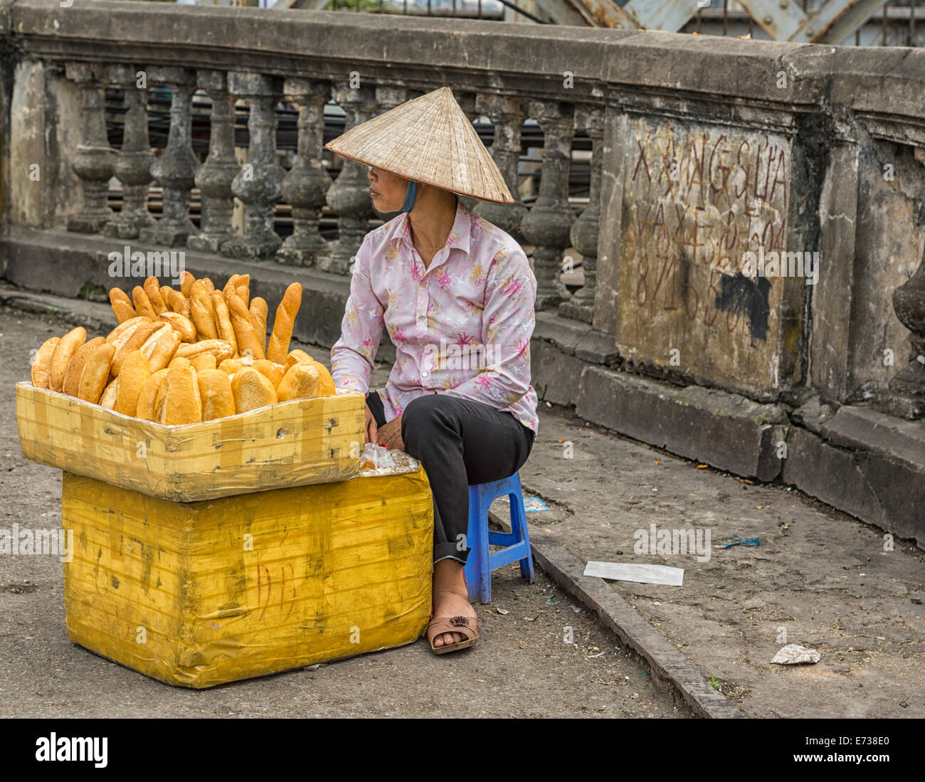 Young woman selling fresh baked bread in the street. Stock Photo