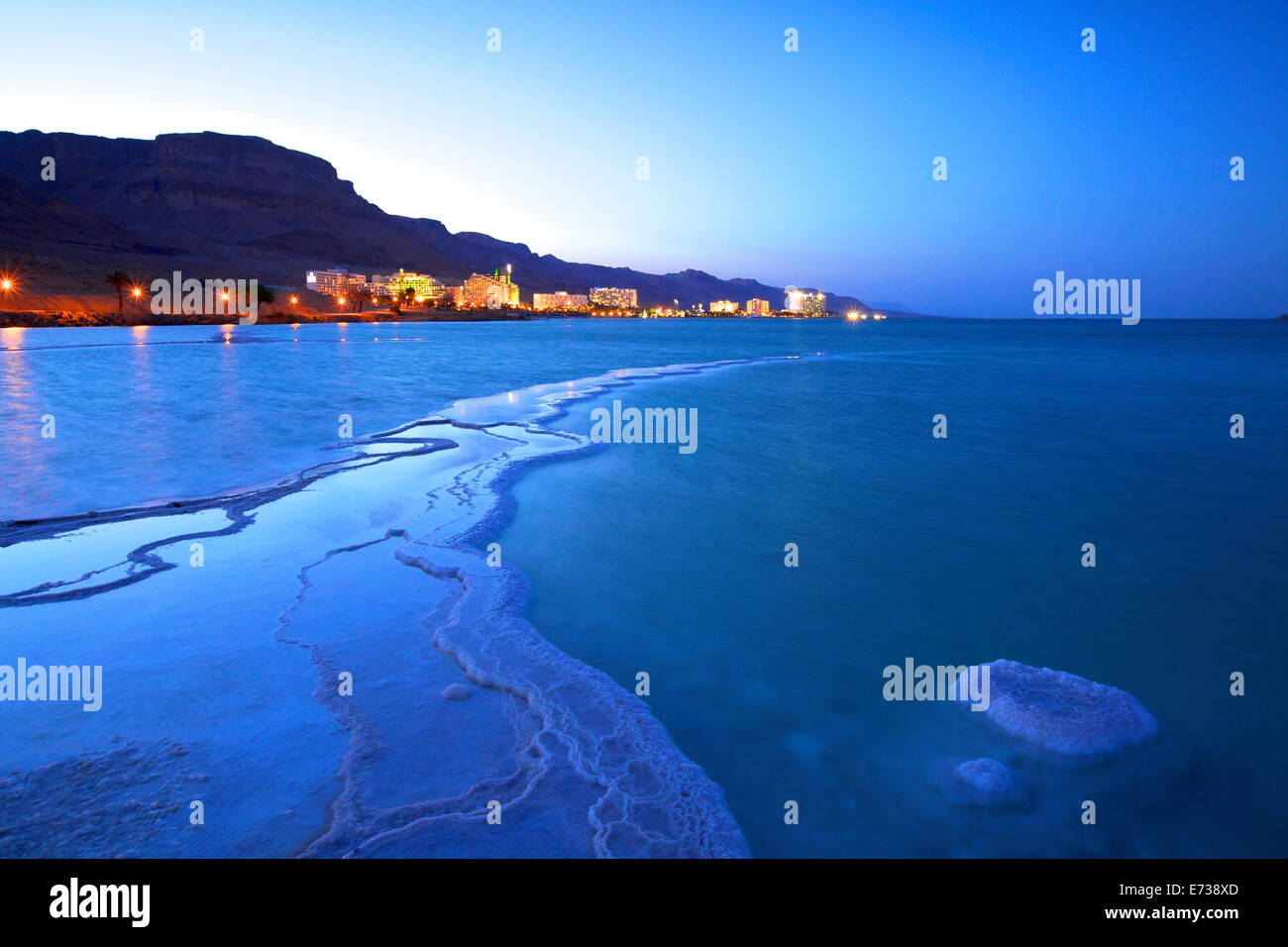 Salt deposit in foreground looking towards Ein Bokek, Ein Bokek, Dead Sea, Israel, Middle East Stock Photo