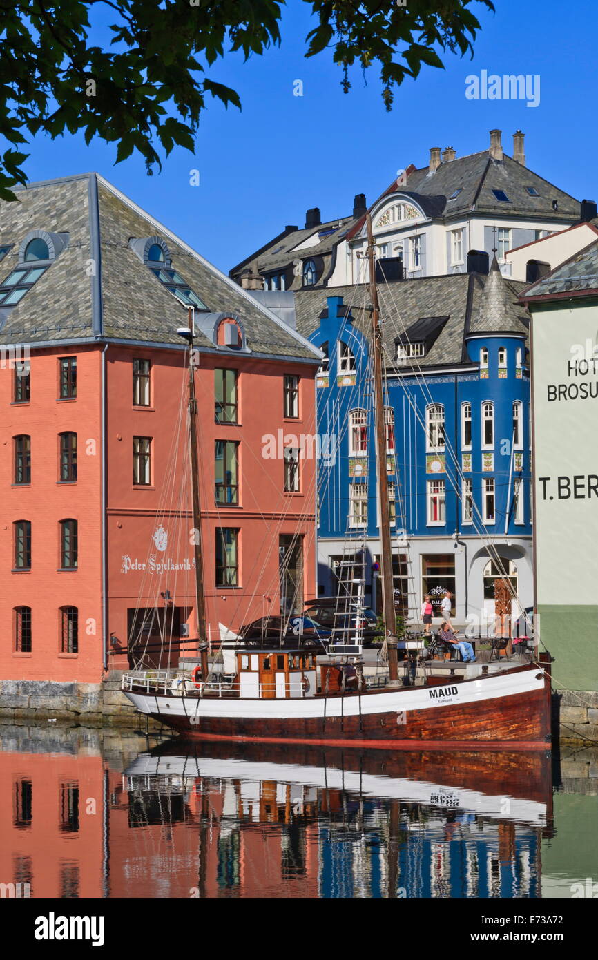 Art Nouveau buildings and reflections with boat, Alesund, More og Romsdal, Norway, Scandinavia, Europe Stock Photo