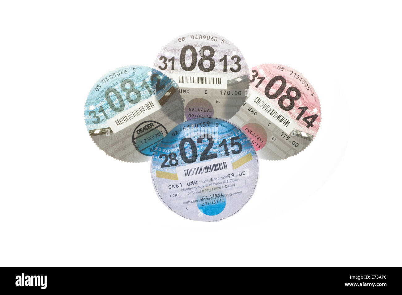 Four UK HMRC DVLC Car Tax discs backlit on a pure white background to show watermarks. Stock Photo