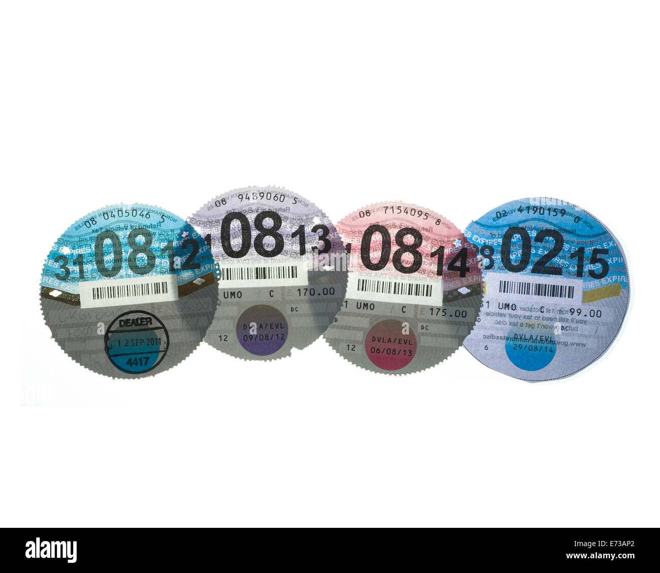 Four UK HMRC DVLC Car Tax discs backlit on a pure white background to show watermarks. Stock Photo