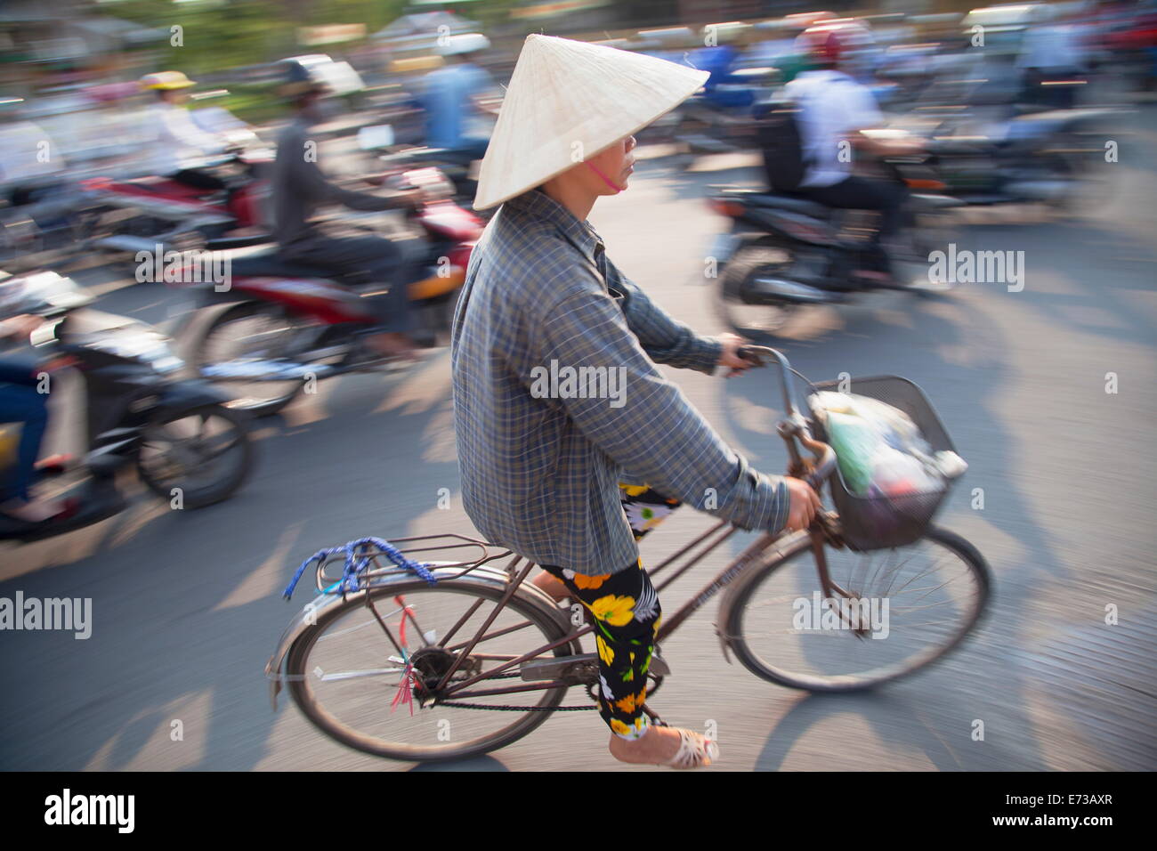 Woman riding bicycle, Hue, Thua Thien-Hue, Vietnam, Indochina, Southeast Asia, Asia Stock Photo